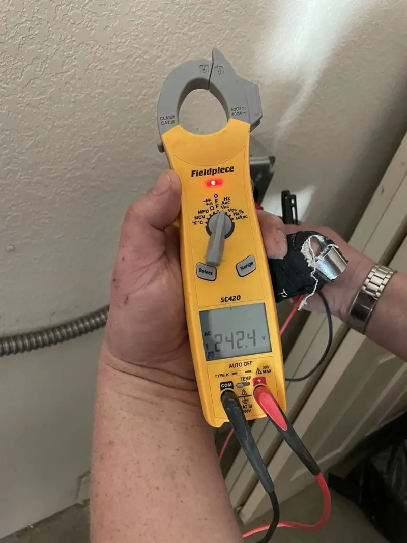 Voltage testing with clamp meter during Ceiling Fan Installation in Monitor